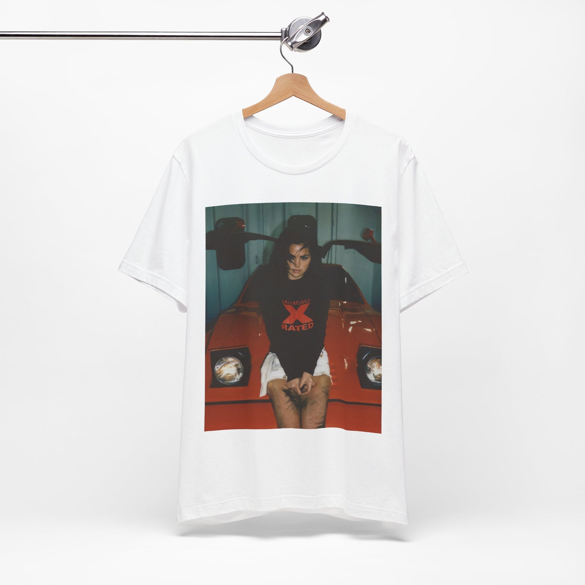 A black graphic t-shirt featuring a photo or graphic of Selena Gomez with a car, designed with an 'X Rated' or edgy aesthetic.
