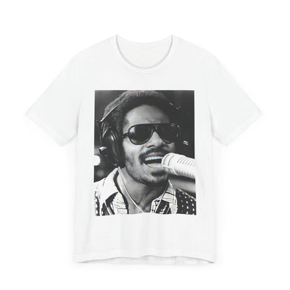 A black graphic t-shirt featuring a graphic of Stevie Wonder as a timeless visionary.