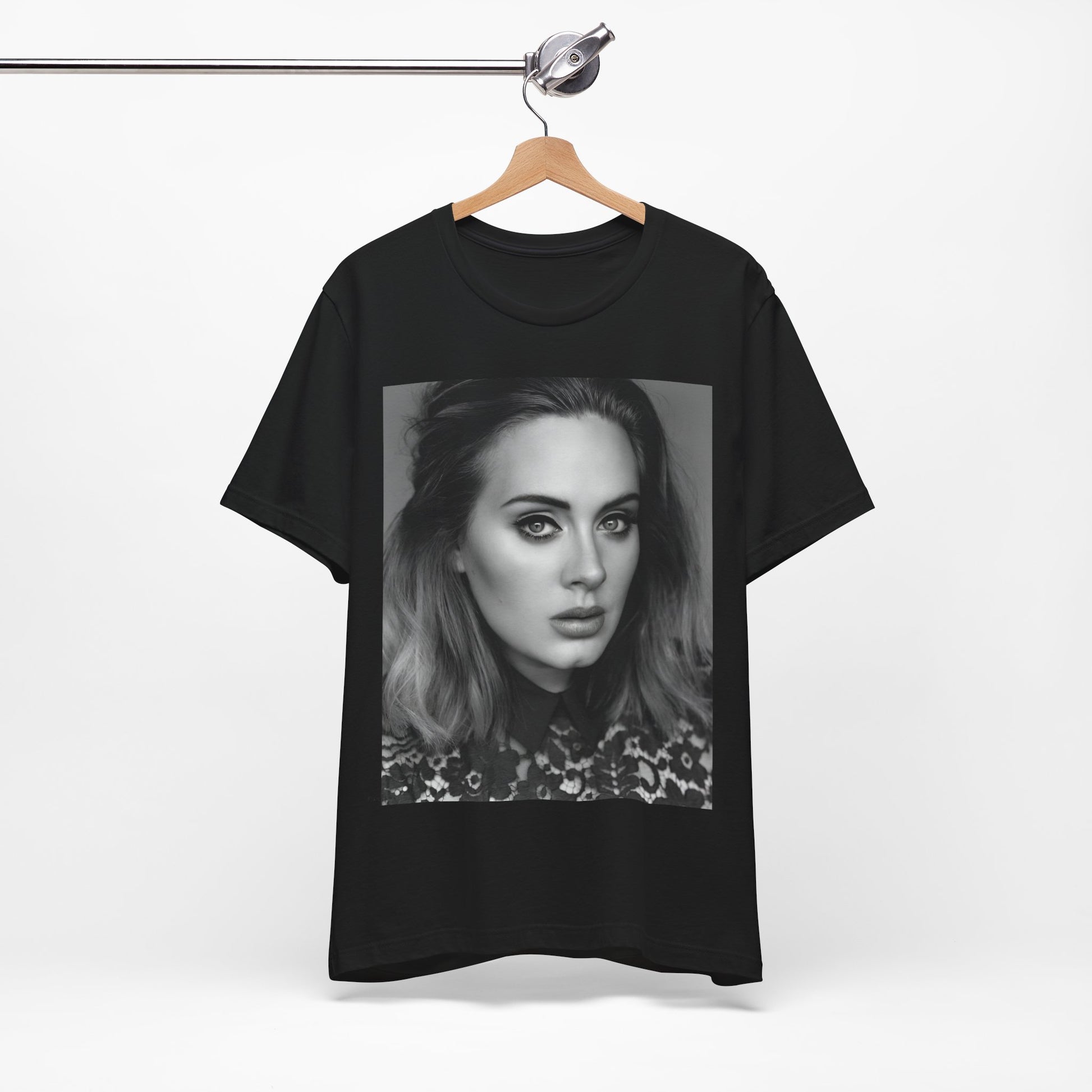 A black graphic t-shirt featuring a classic black and white, monochrome portrait of Adele, showing her with a serene or thoughtful expression.