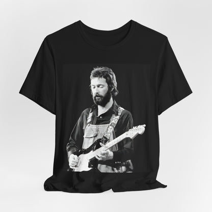 A black graphic t-shirt featuring a graphic or photo of Eric Clapton performing live on stage with his guitar.