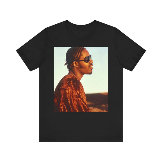 A black graphic t-shirt featuring a graphic of Stevie Wonder as an iconic style pop innovator.