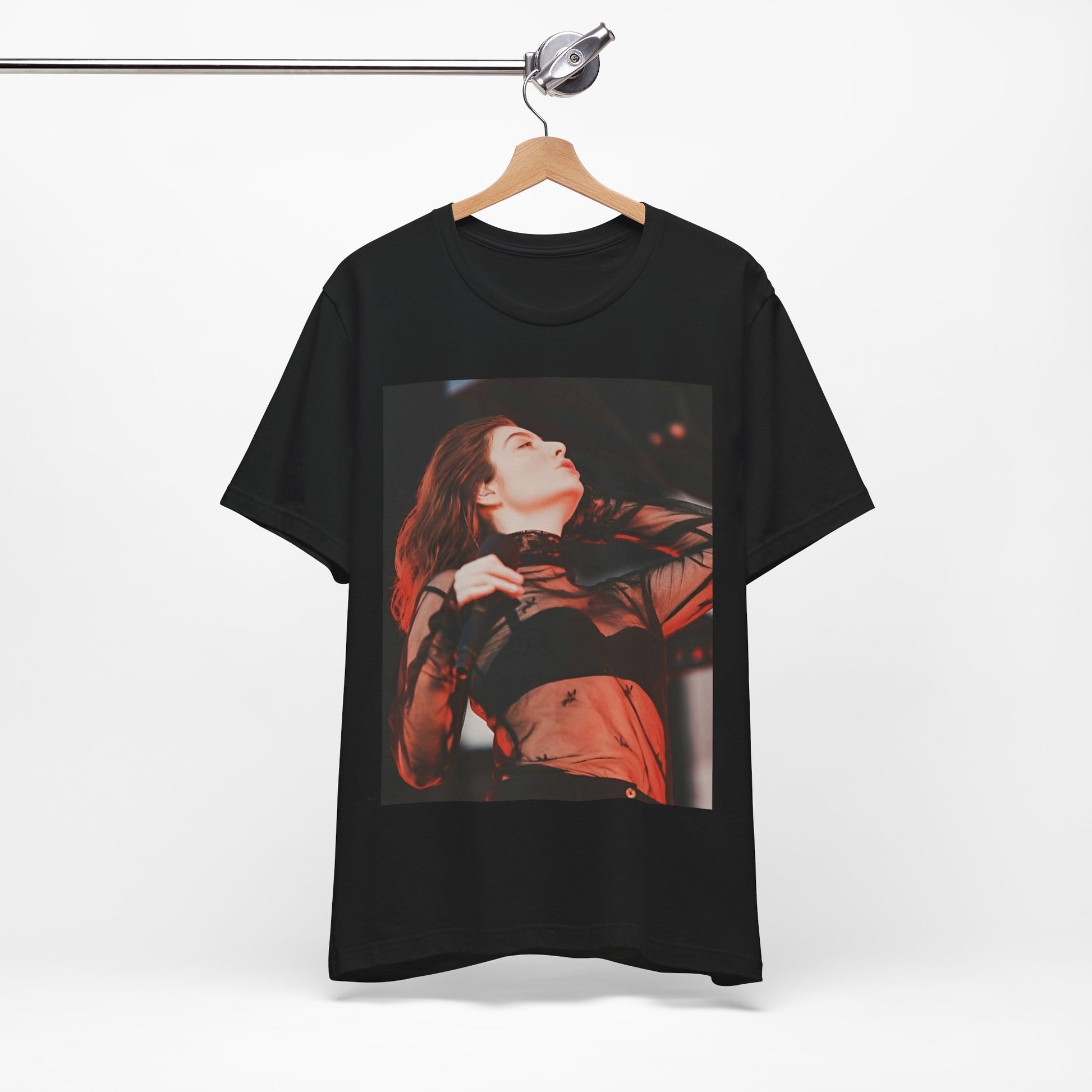 A black graphic t-shirt featuring a graphic of Lorde emphasizing raw emotion.