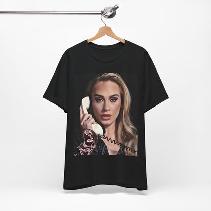 A black graphic t-shirt featuring a black and white candid photo of Adele with a phone to her ear, showing a thoughtful or emotional expression.