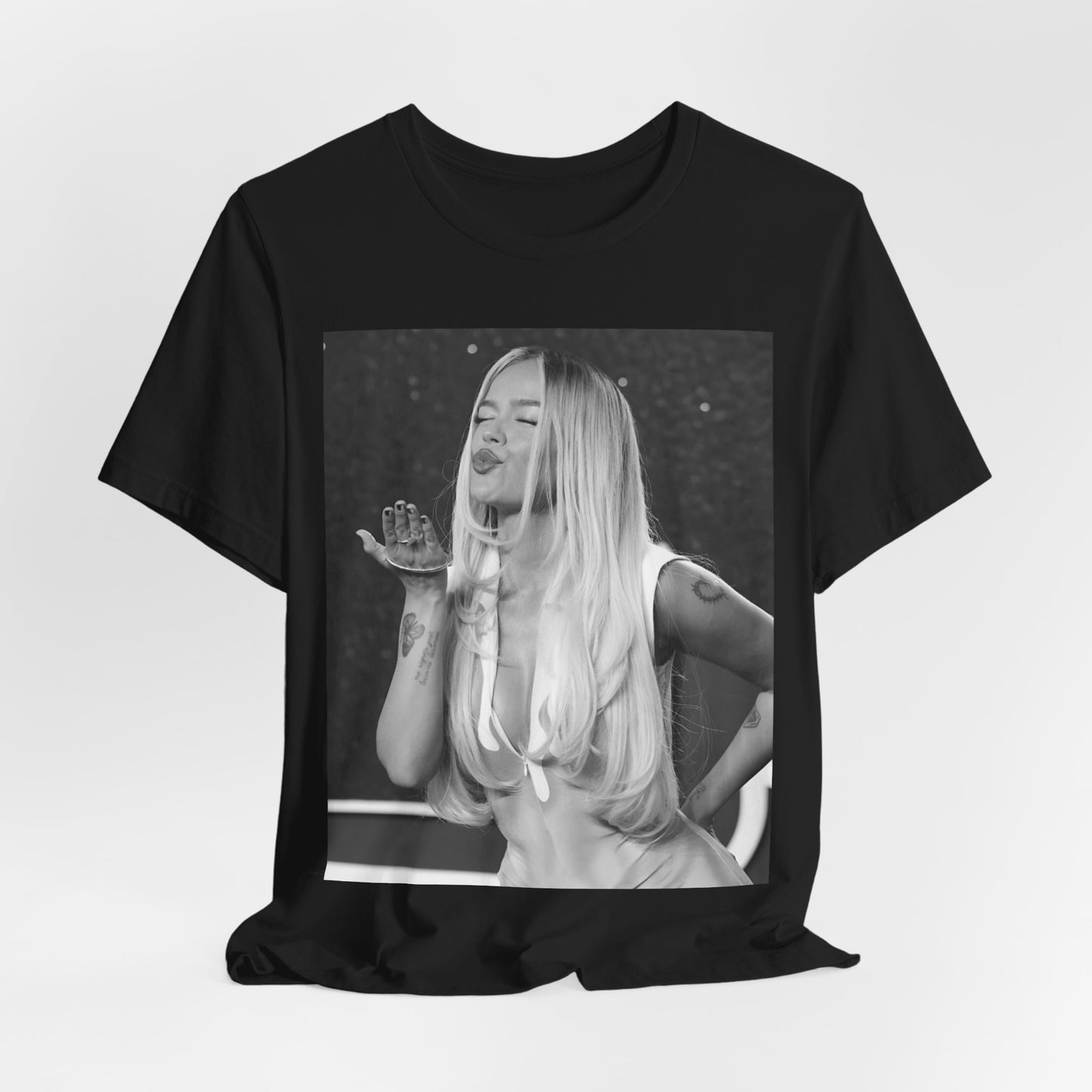 A black graphic t-shirt featuring a graphic of Karol G with a 'La Bichota Kiss' theme.