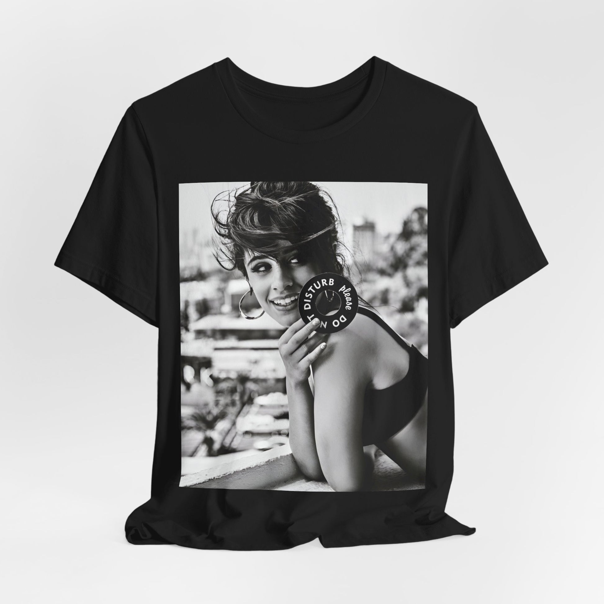 A black graphic t-shirt featuring a black and white photo or graphic of Camila Cabello in an iconic style.