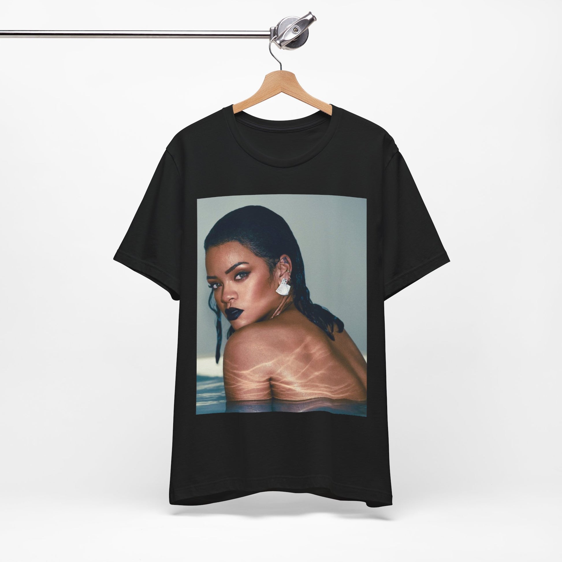 A black graphic t-shirt featuring a vintage pop icon graphic of Rihanna.