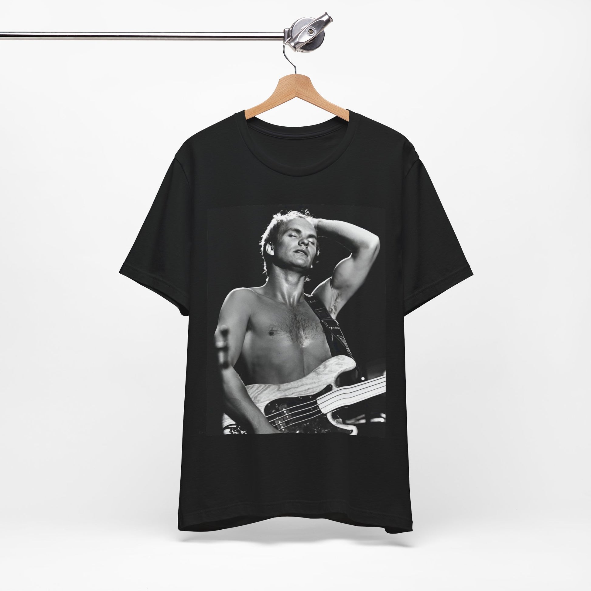 A black graphic t-shirt featuring a graphic or photo of Sting performing live on stage in 1983.