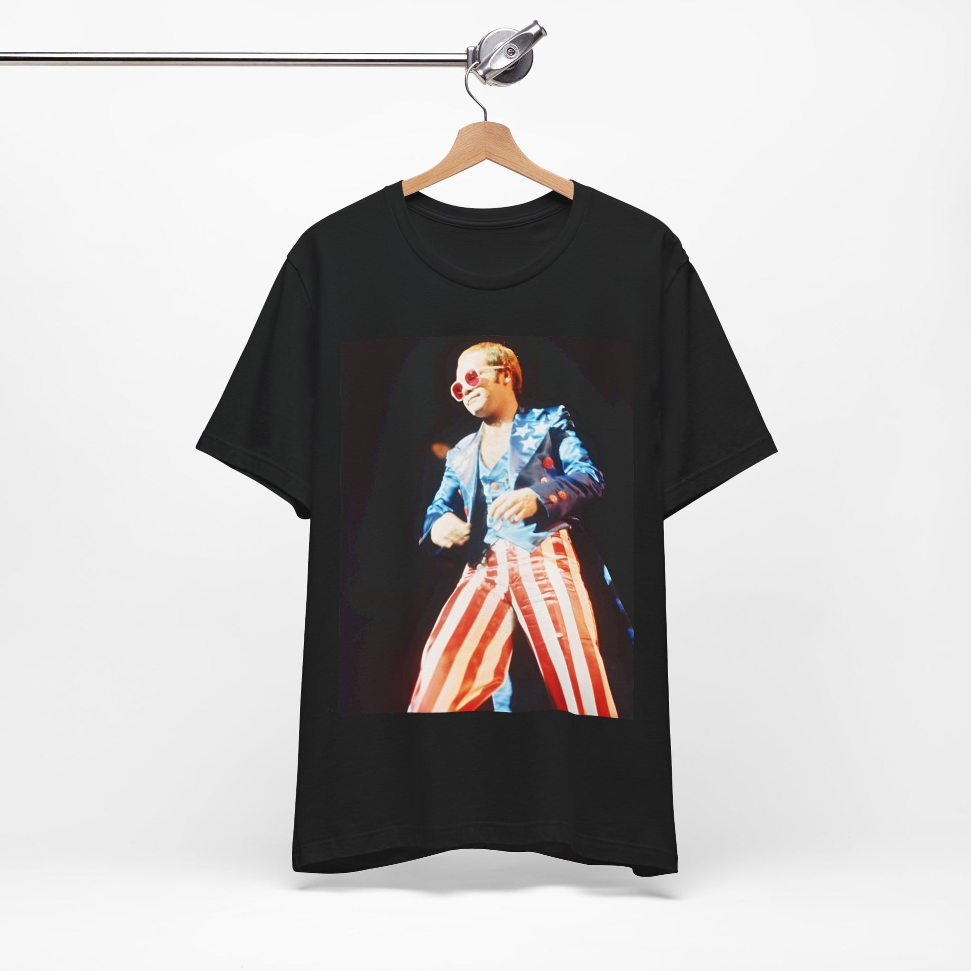 A black graphic t-shirt featuring a graphic related to Elton John's 70s America tour.