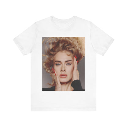 A black graphic t-shirt featuring a detailed, artistic black and white portrait of Adele with her hair dramatically caught in a breeze around her face and her hands gently placed on her cheeks.