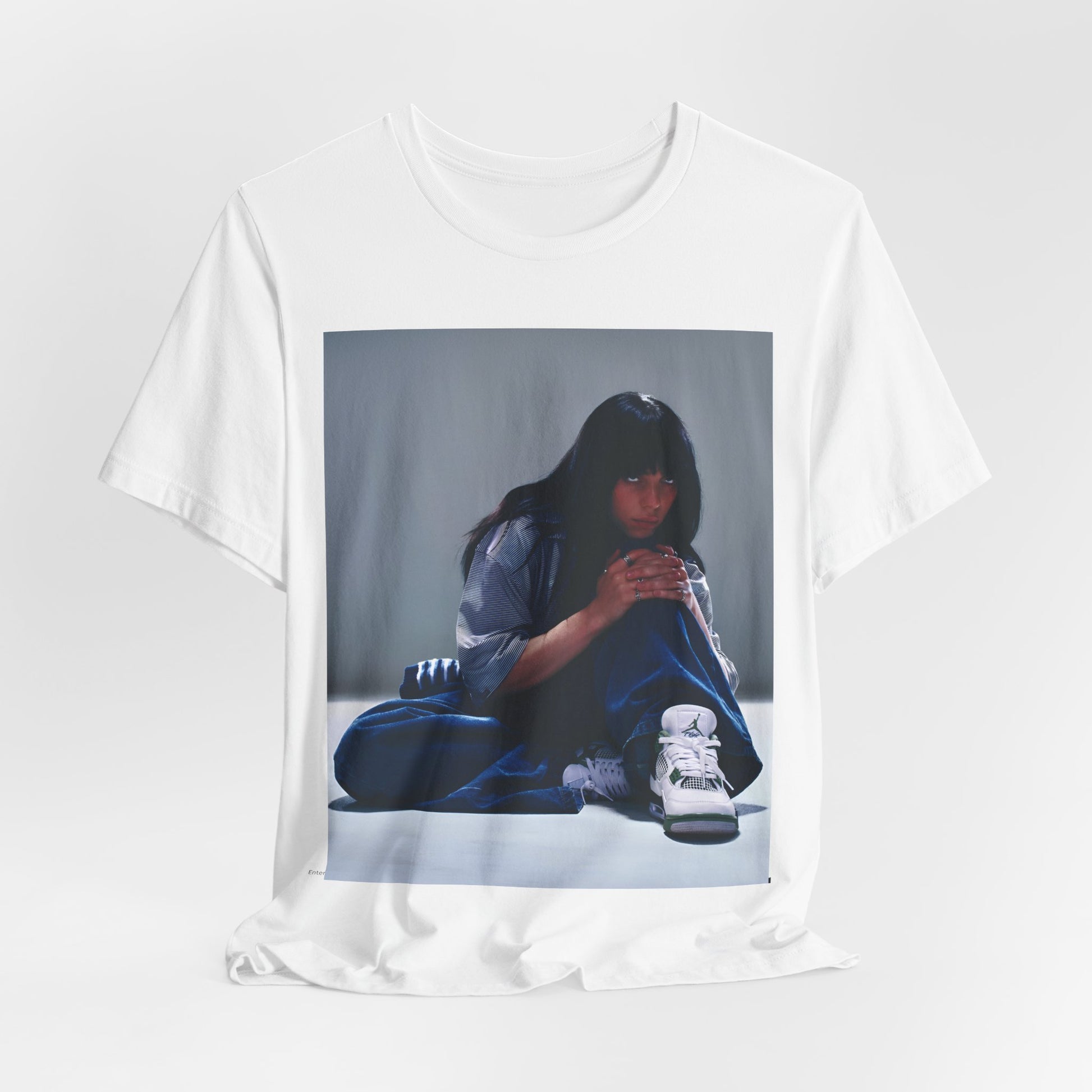 An artistic and slightly melancholic graphic t-shirt inspired by Billie Eilish's song "Lovely," featuring soft colors and a dreamy style.