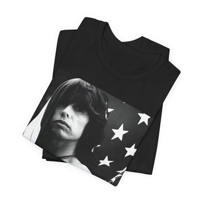 A black graphic t-shirt featuring a retro 70s-style illustration or photo of Aerosmith, integrated with elements of the American flag.