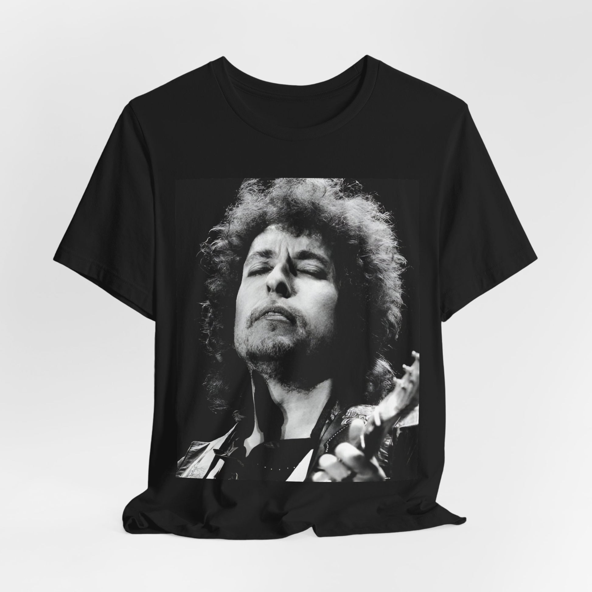 A black graphic t-shirt featuring a retro black and white graphic or photo of Bob Dylan performing live.