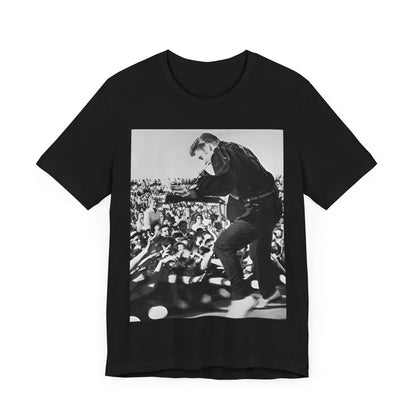 A black graphic t-shirt featuring a retro photo of Elvis Presley performing live in concert in the 1950s.