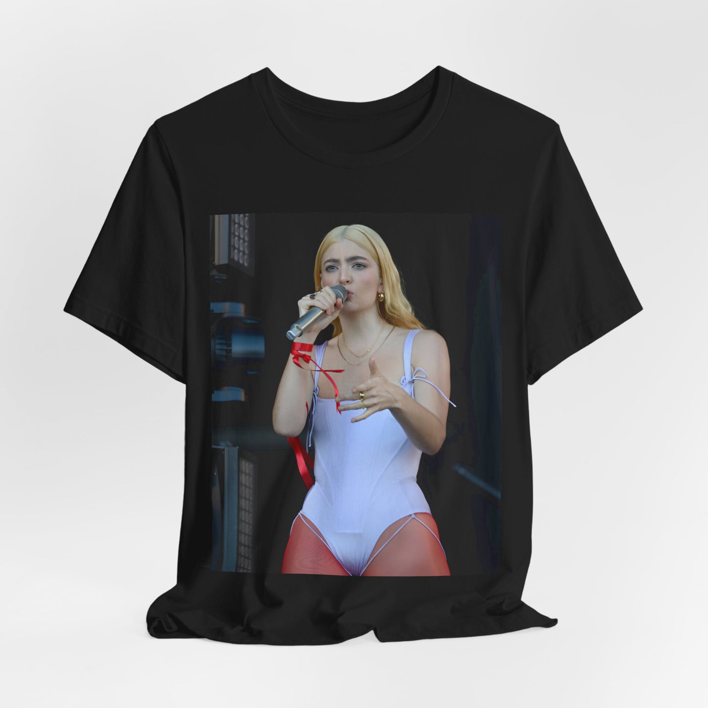 A black graphic t-shirt featuring a graphic or photo of Lorde performing on stage in a cool alternative music style.