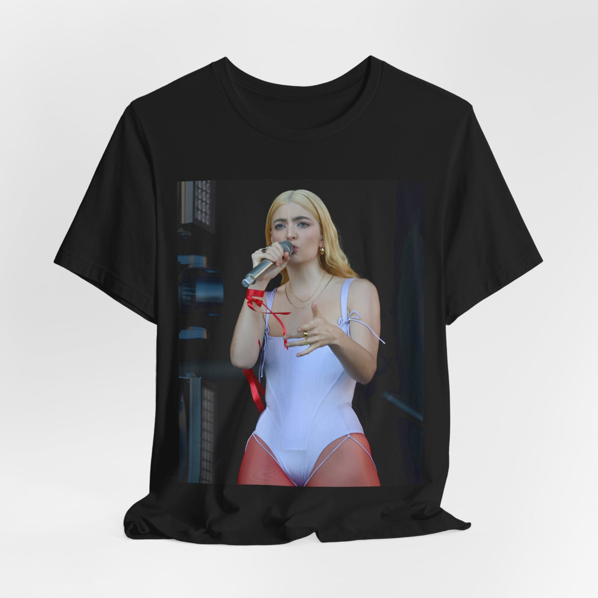 A black graphic t-shirt featuring a graphic or photo of Lorde performing on stage in a cool alternative music style.