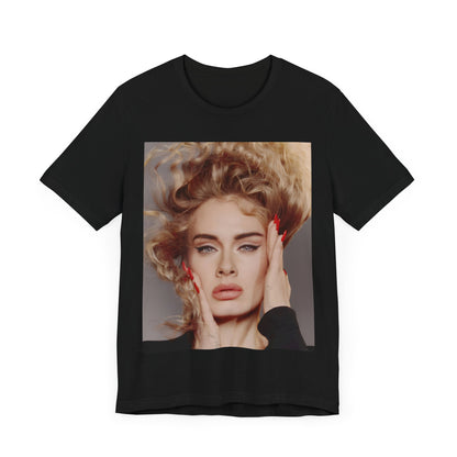 A black graphic t-shirt featuring a detailed, artistic black and white portrait of Adele with her hair dramatically caught in a breeze around her face and her hands gently placed on her cheeks.