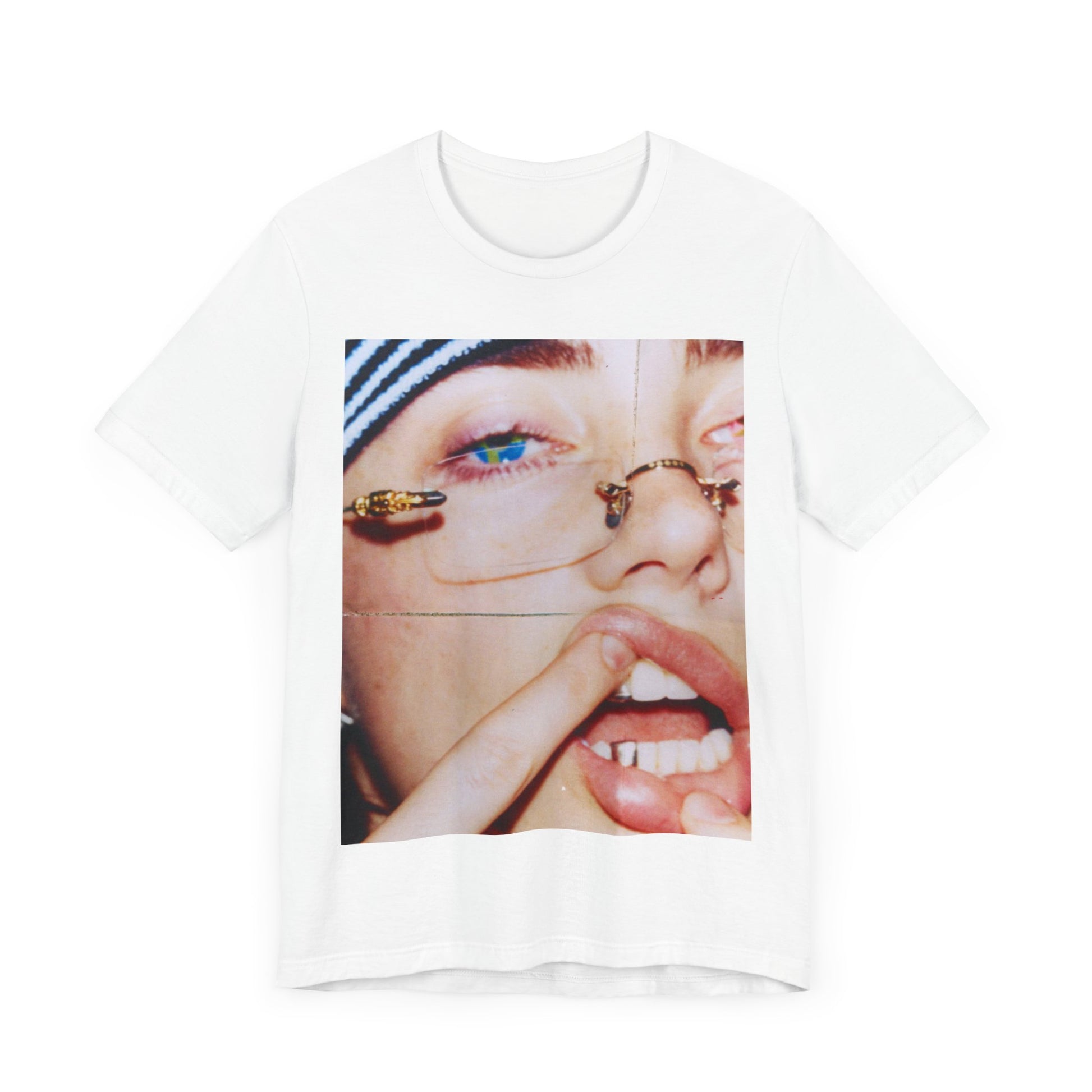 A direct, unfiltered, close-up portrait of Billie Eilish with dark hair looking straight at the camera, printed on a t-shirt.