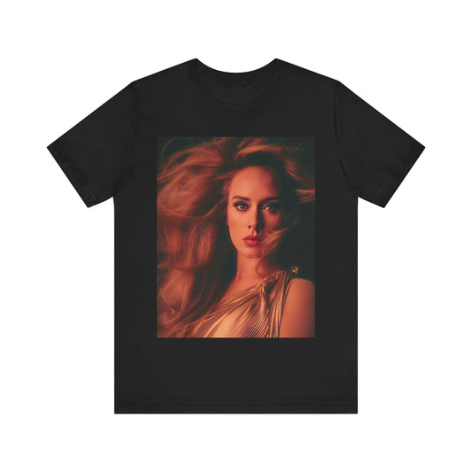 A black graphic t-shirt featuring a glamorous portrait of Adele wearing a golden gown, with voluminous hair, bathed in warm lighting, giving an editorial look.