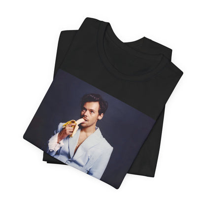 A black graphic t-shirt featuring a graphic related to Harry Styles and his One Direction legacy.
