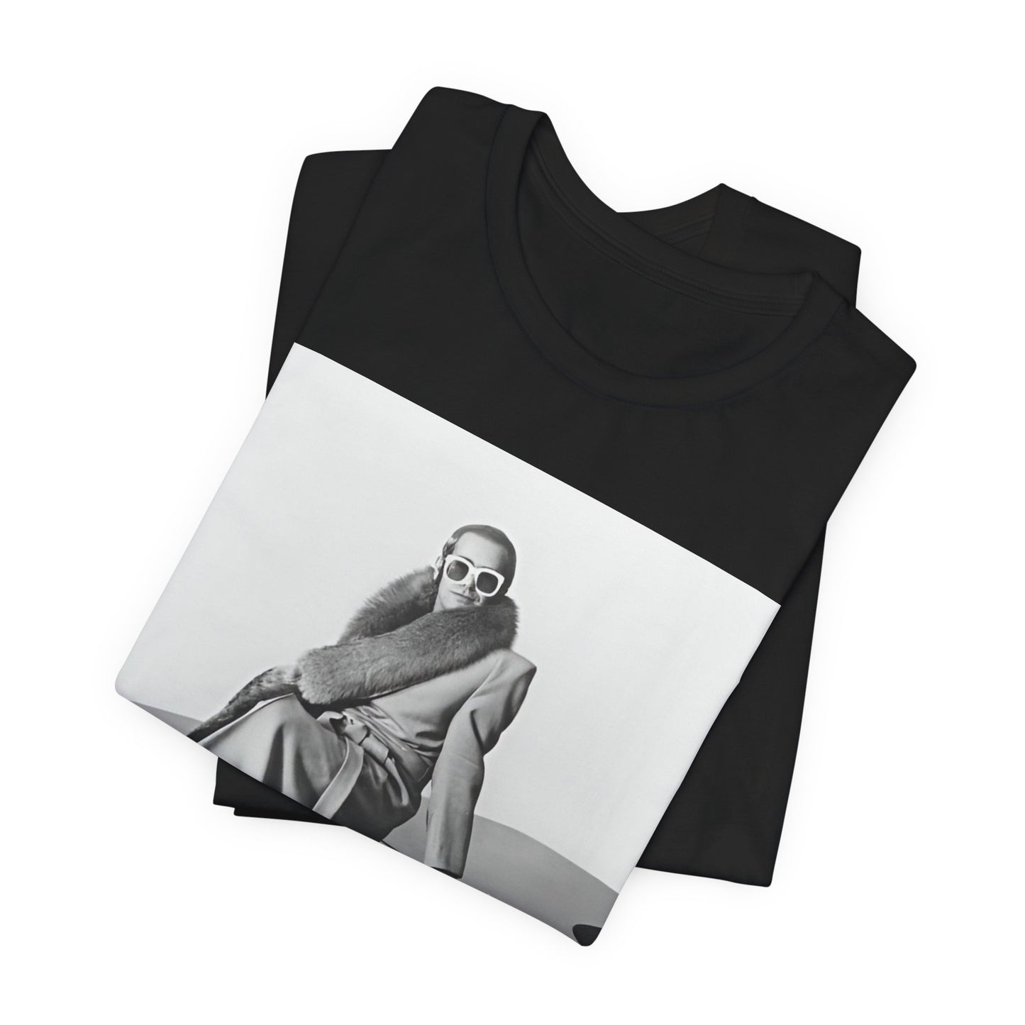 A black graphic t-shirt featuring a black and white photo of Elton John playing the piano.