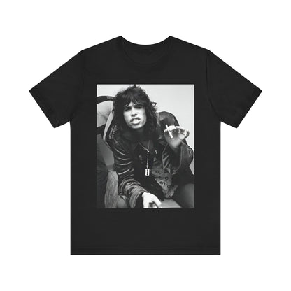 A black graphic t-shirt featuring a retro 70s photo of Aerosmith band members lounging in leather, exuding a cool, classic rock vibe.