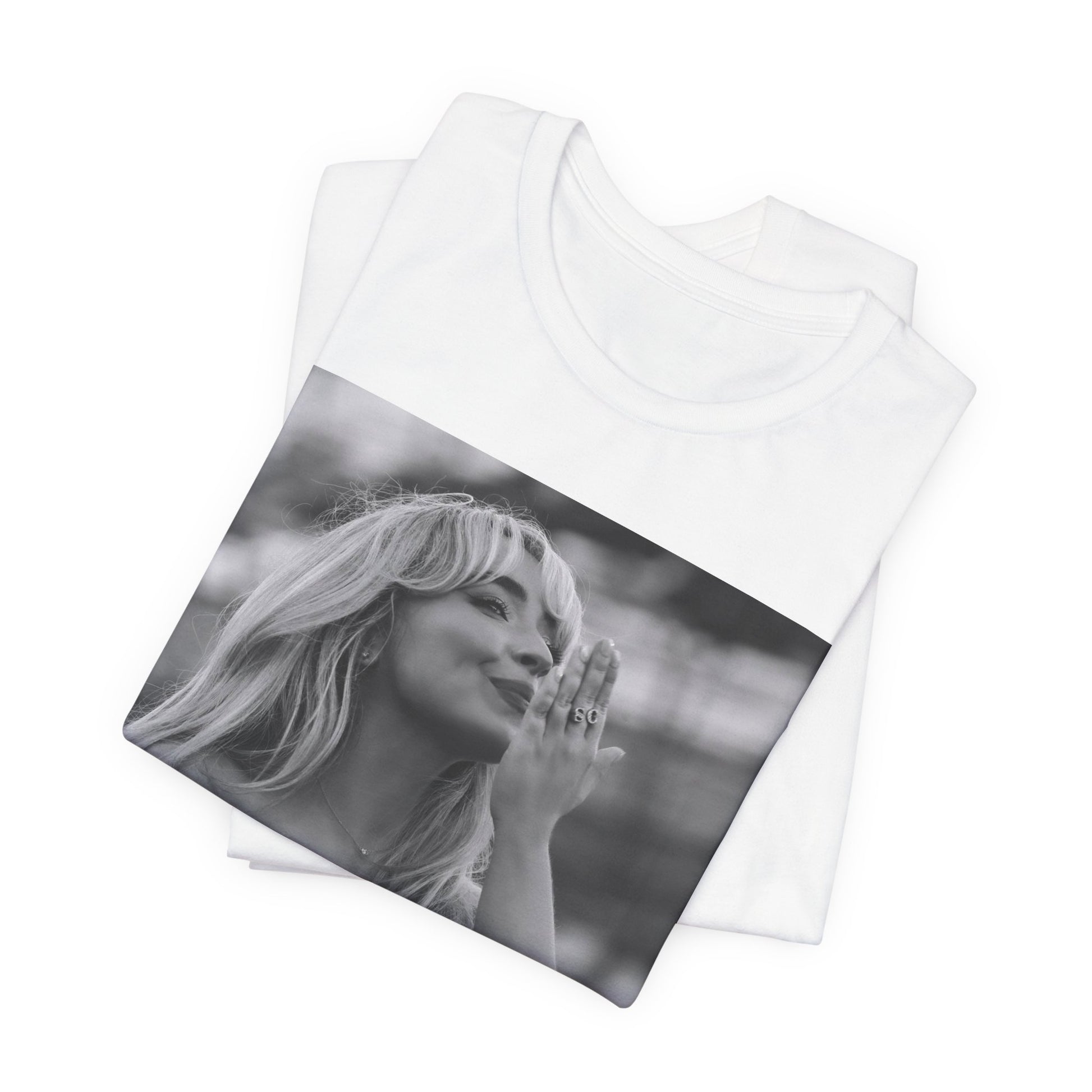 A black graphic t-shirt featuring a graphic or photo of Sabrina Carpenter kissing on stage during a performance.