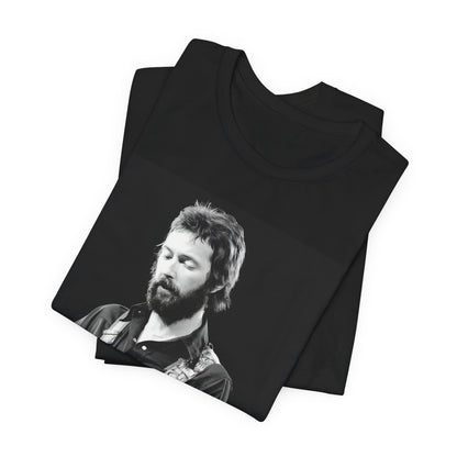 A black graphic t-shirt featuring a graphic or photo of Eric Clapton performing live on stage with his guitar.