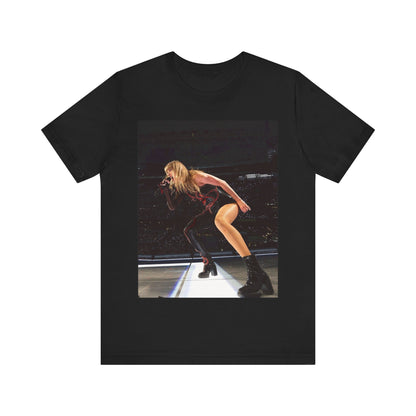 A black graphic t-shirt featuring a fierce graphic of Taylor Swift on stage.