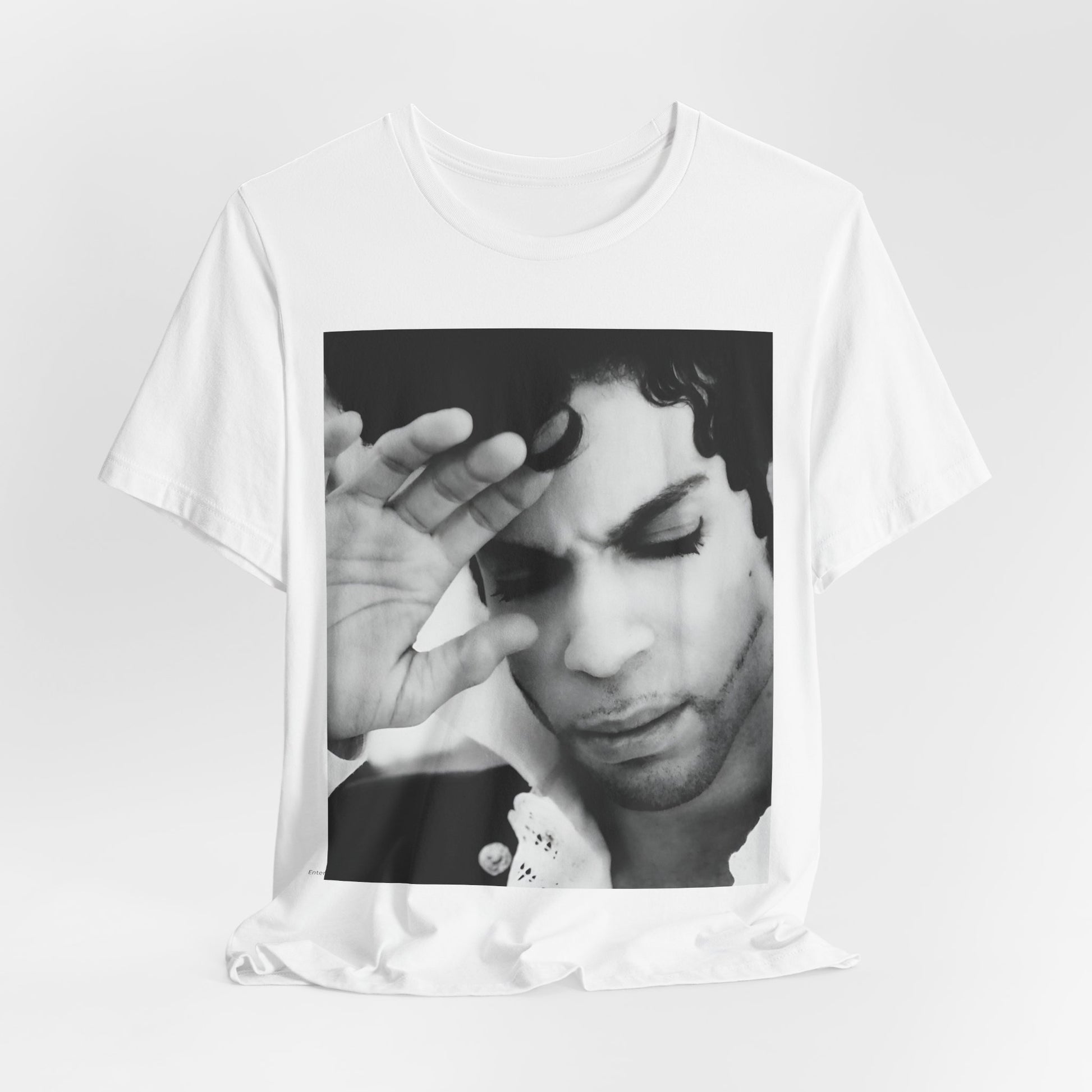 A black graphic t-shirt featuring a black and white graphic or photo portrait of Prince.