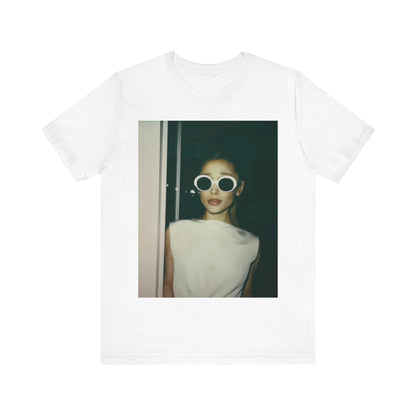 A black graphic t-shirt featuring a retro Polaroid-style photo of Ariana Grande.
