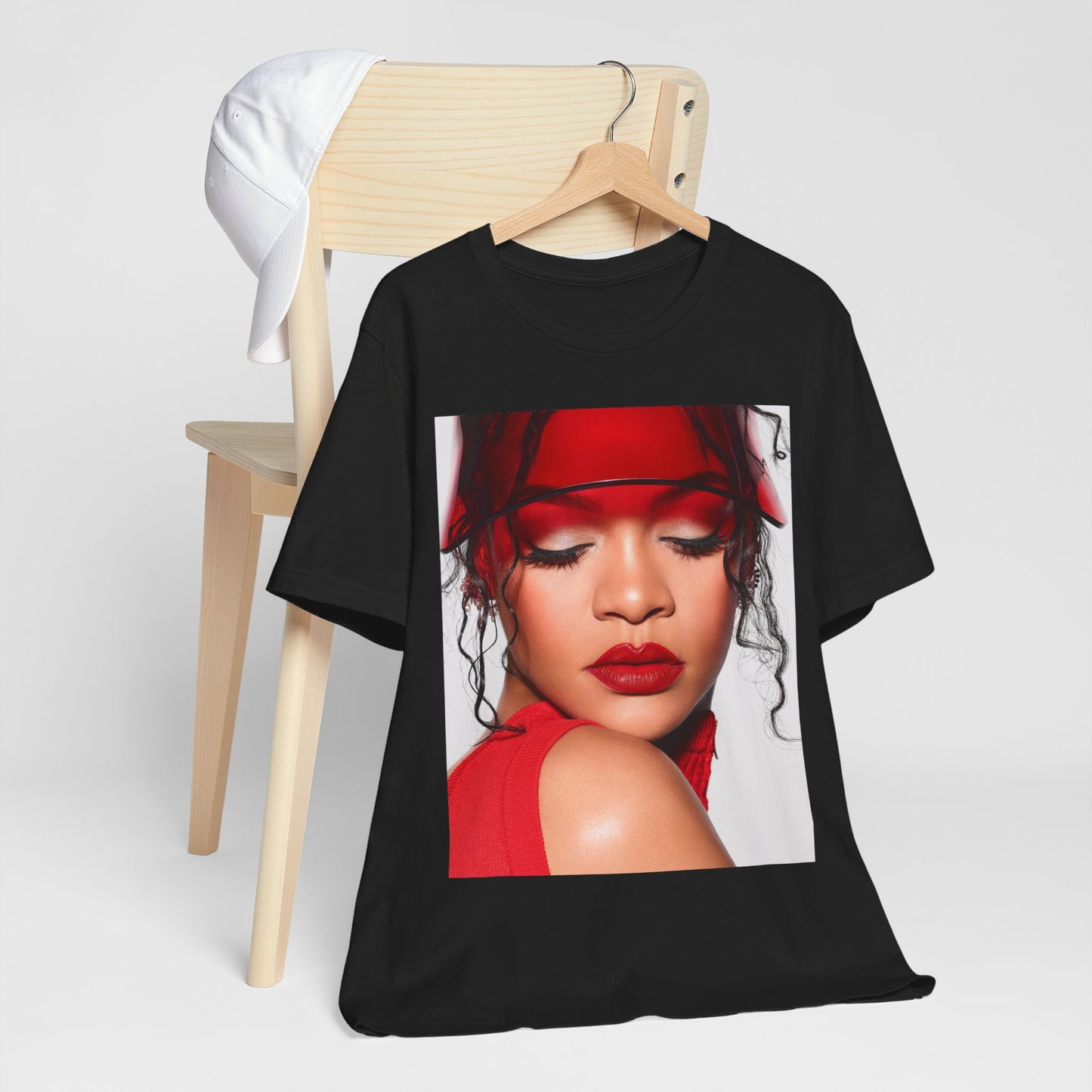 A black graphic t-shirt featuring a casual pop fan graphic of Rihanna.