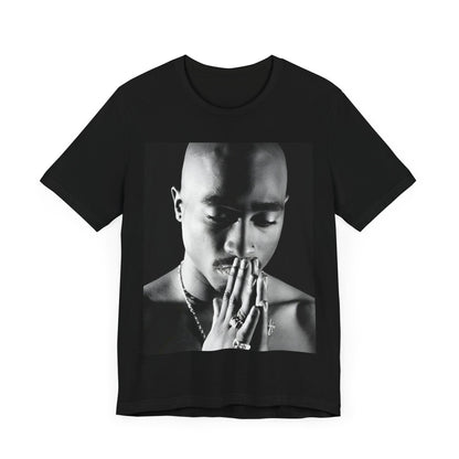 A black graphic t-shirt featuring a black and white streetwear rebel graphic of Tupac.