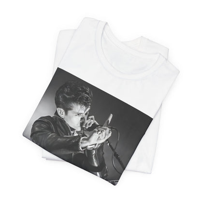 A black graphic t-shirt featuring a dynamic black and white graphic or photo of Arctic Monkeys performing live, emphasizing energy.