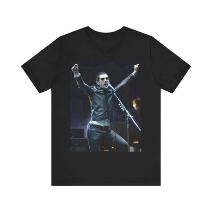 A black graphic t-shirt featuring a graphic or photo of Arctic Monkeys performing live on stage, with a Britpop aesthetic.