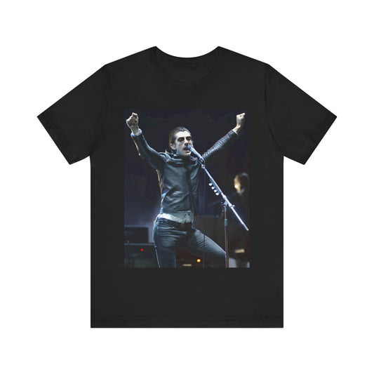 A black graphic t-shirt featuring a graphic or photo of Arctic Monkeys performing live on stage, with a Britpop aesthetic.