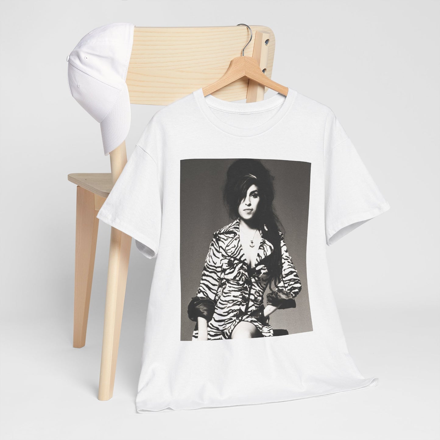 A black graphic t-shirt featuring a vintage black and white portrait of Amy Winehouse, showing her with her signature beehive and soulful expression.