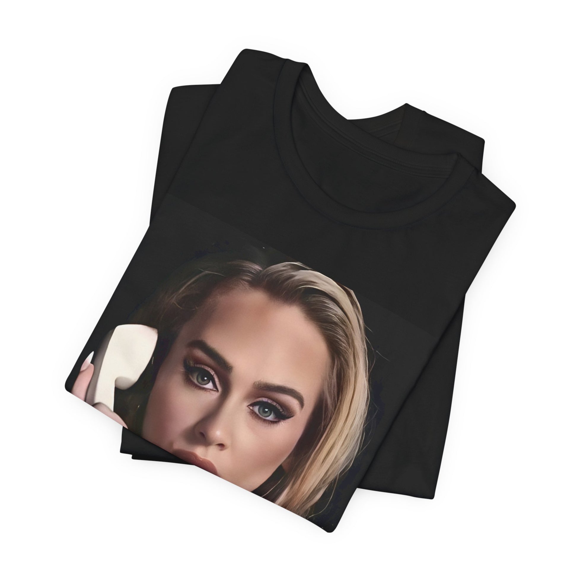 A black graphic t-shirt featuring a black and white candid photo of Adele with a phone to her ear, showing a thoughtful or emotional expression.