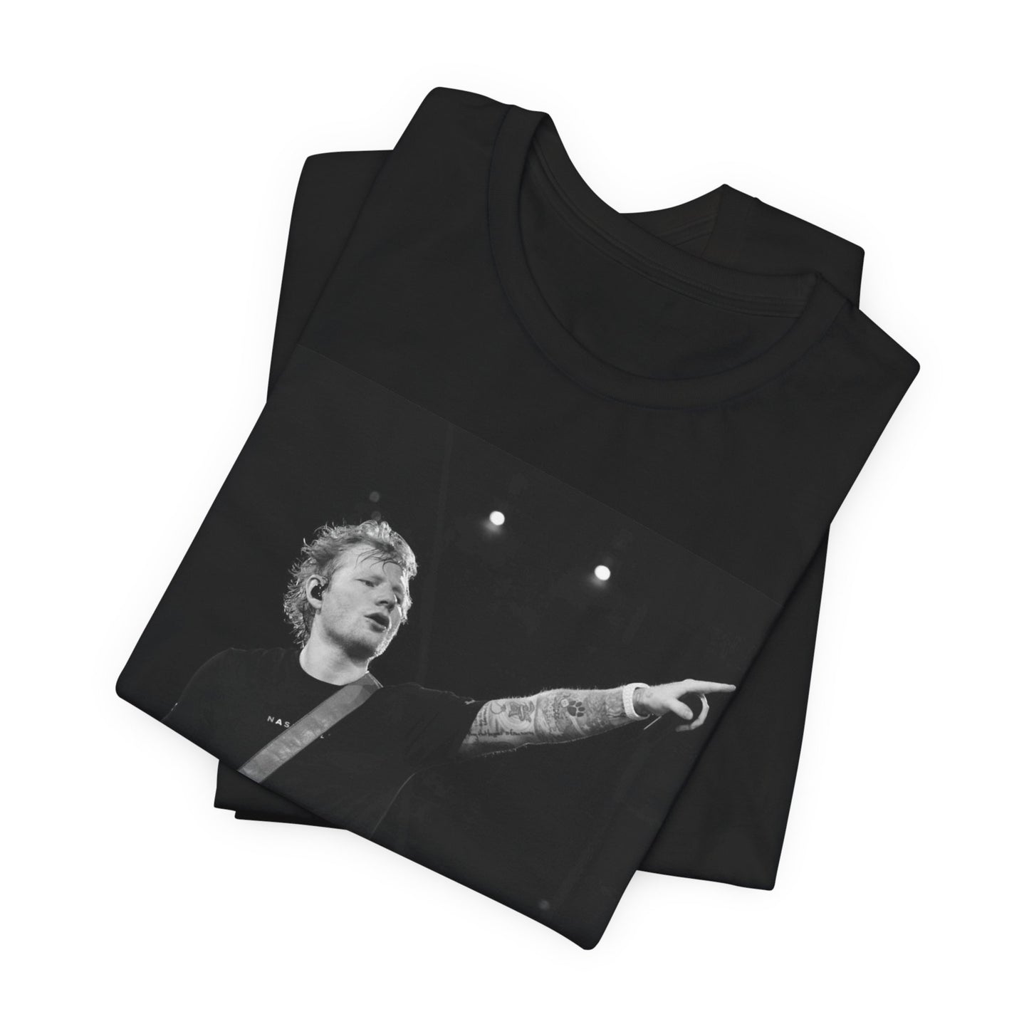 A black graphic t-shirt featuring a black and white graphic or photo of Ed Sheeran performing live on stage.