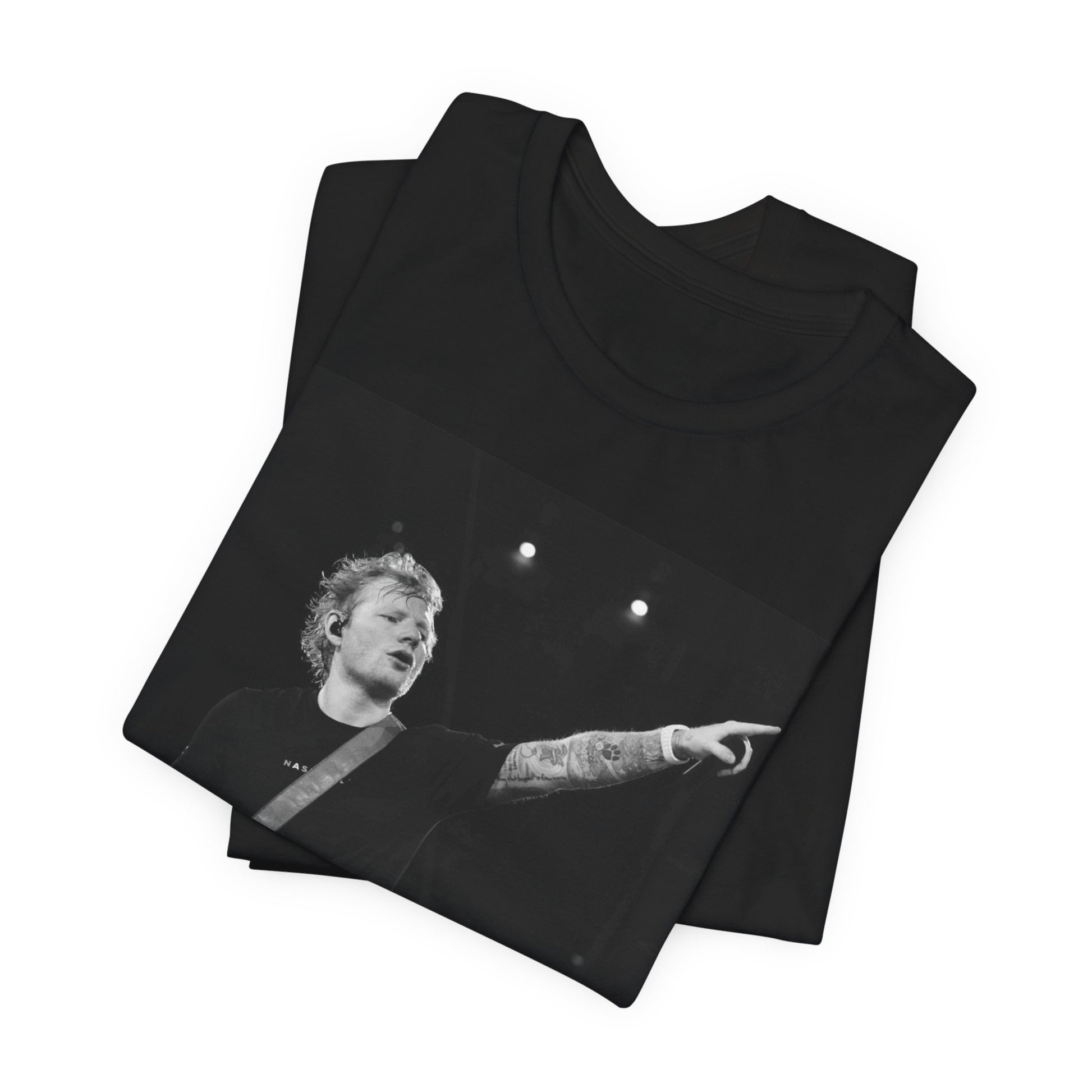 A black graphic t-shirt featuring a black and white graphic or photo of Ed Sheeran performing live on stage.