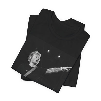 A black graphic t-shirt featuring a black and white graphic or photo of Ed Sheeran performing live on stage.