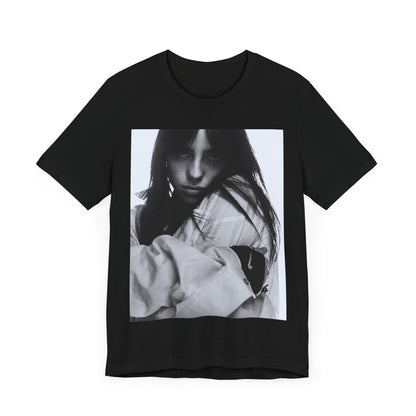 Billie Eilish posing in her signature oversized designer streetwear, printed on a graphic t-shirt.