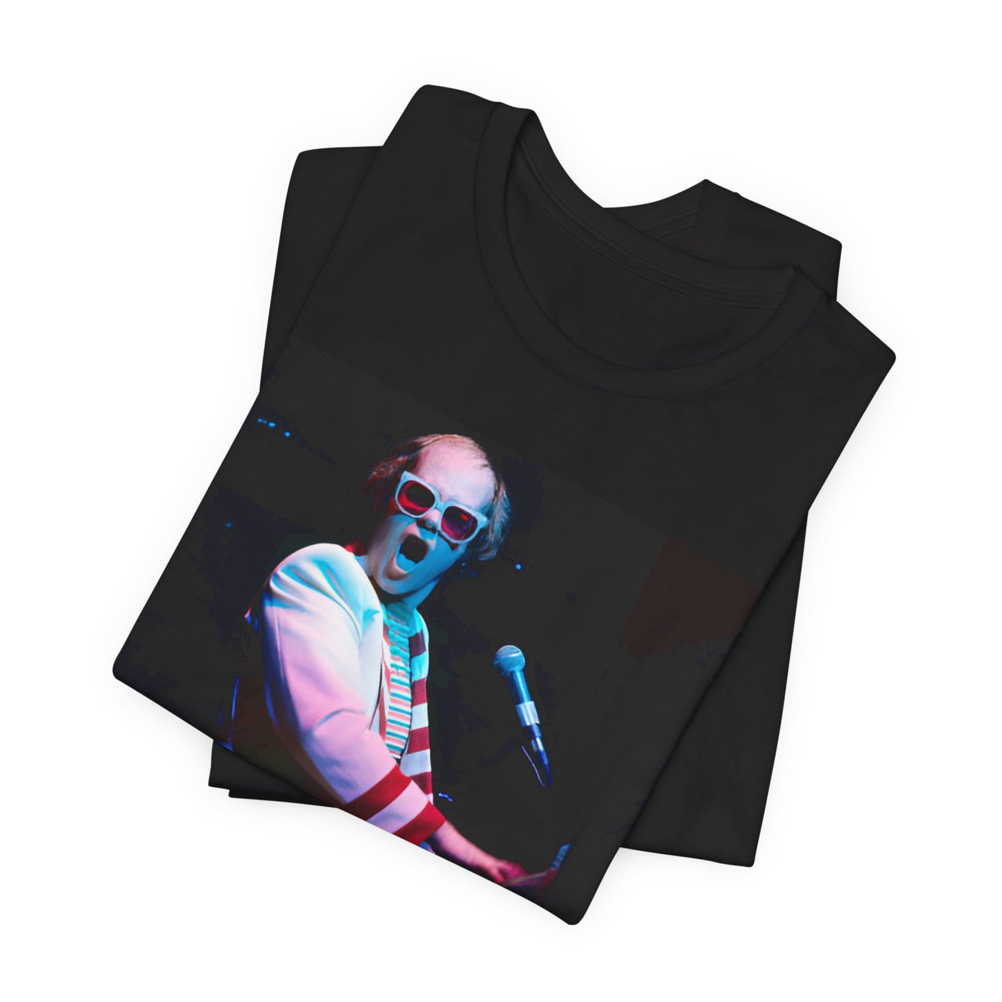 A black graphic t-shirt featuring a photo of Elton John performing live on stage at his piano.
