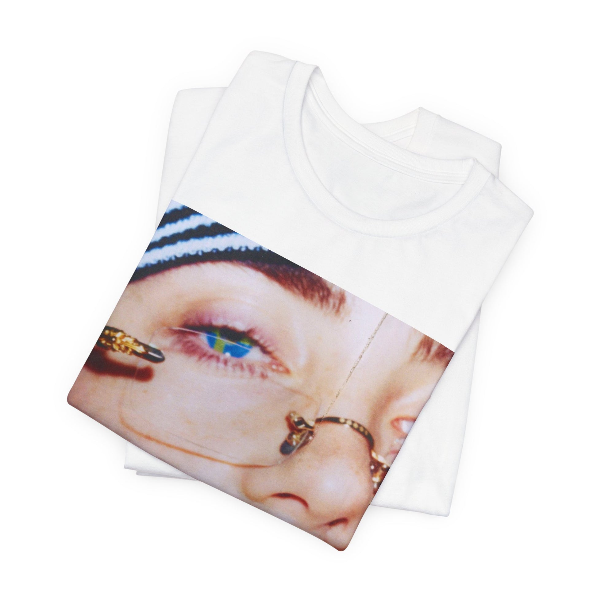 A direct, unfiltered, close-up portrait of Billie Eilish with dark hair looking straight at the camera, printed on a t-shirt.