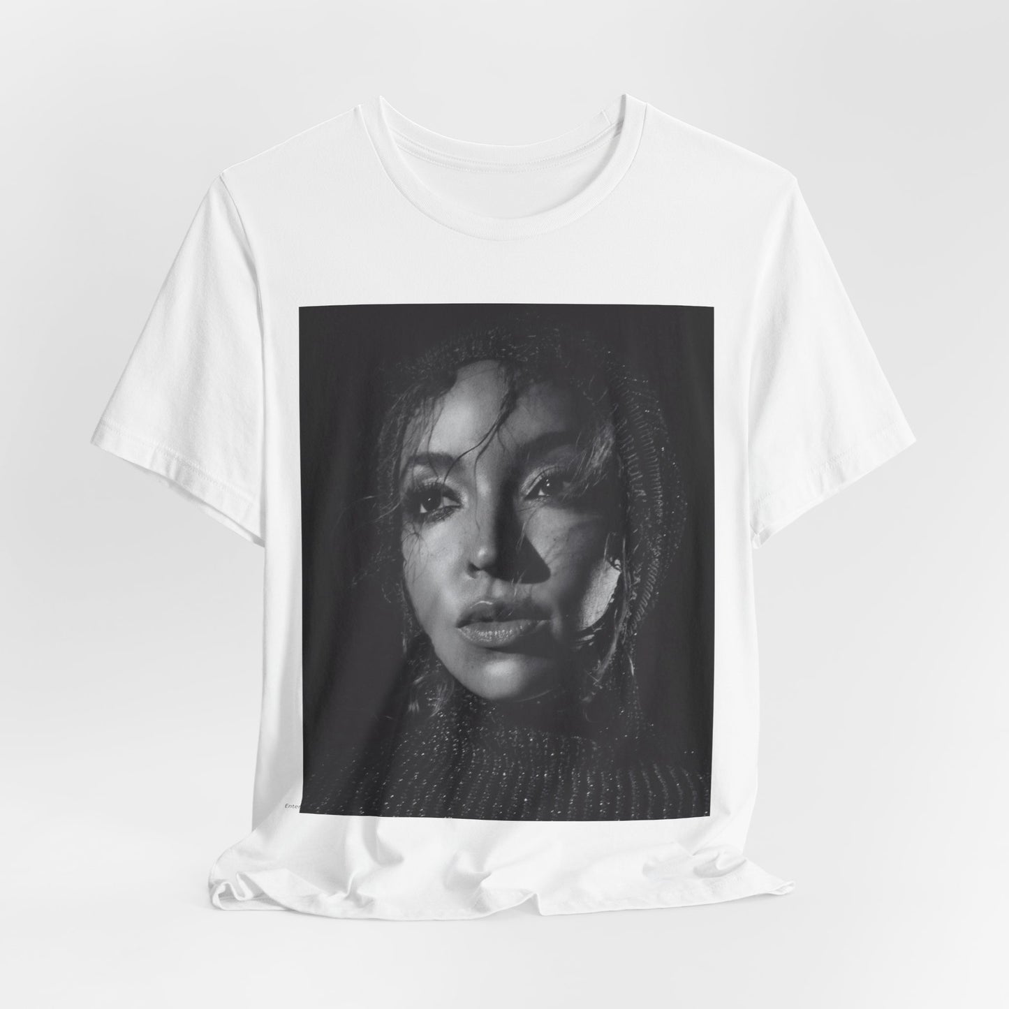 A black graphic t-shirt featuring a black and white portrait photo of Tinashe.