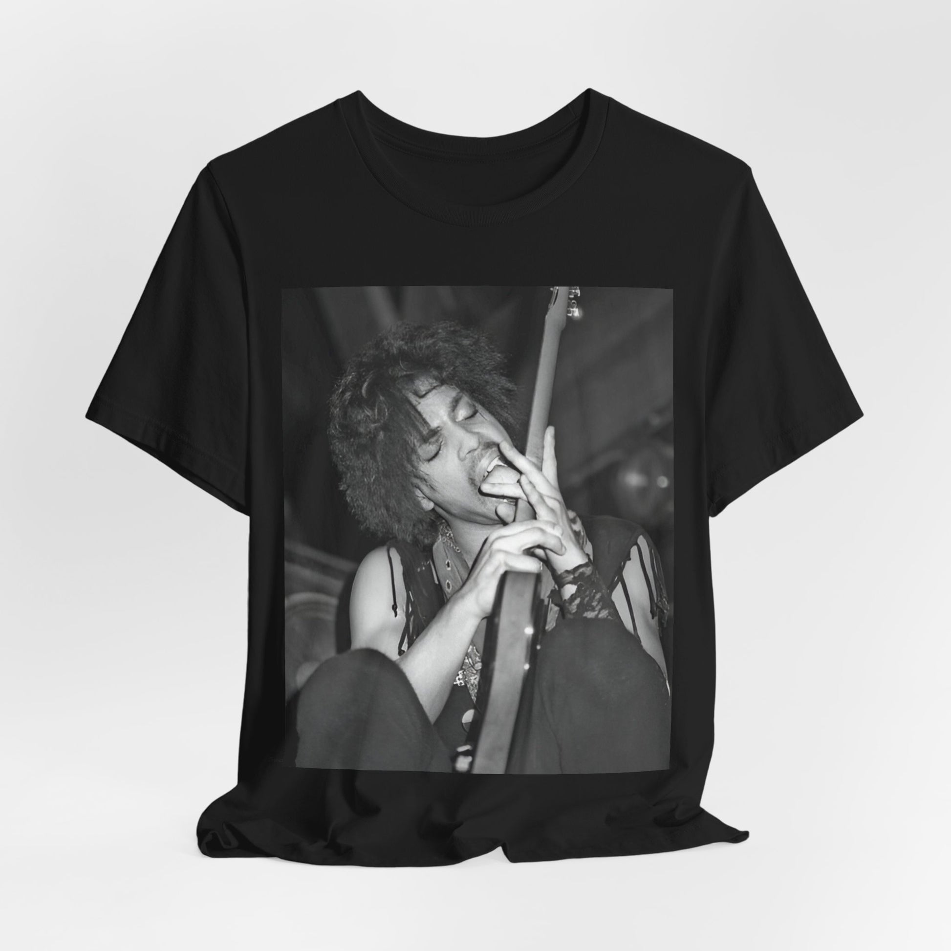 A black graphic t-shirt featuring a graphic or photo of Prince performing wildly on stage.