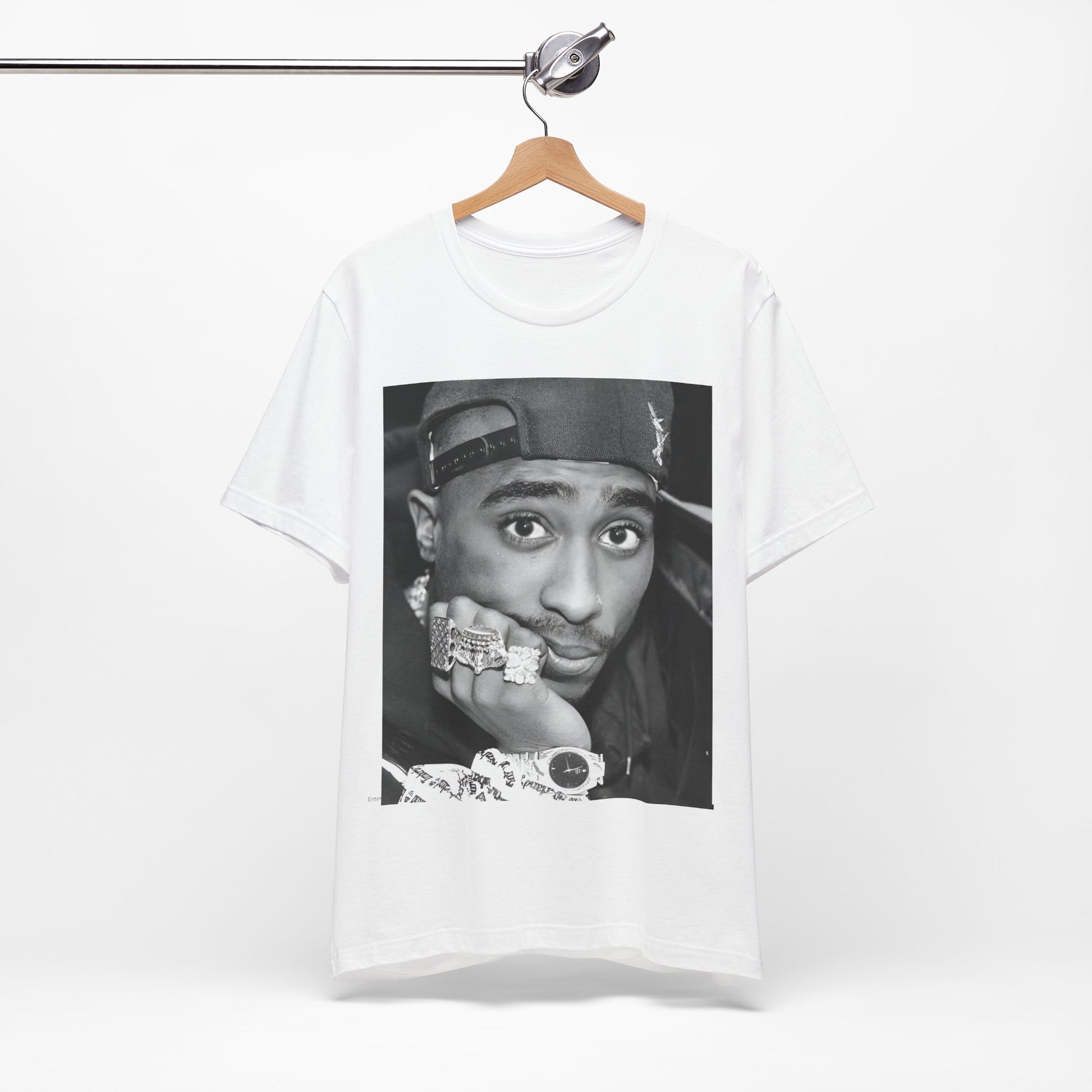 A black graphic t-shirt featuring a bold graphic of Tupac as a rap superstar.