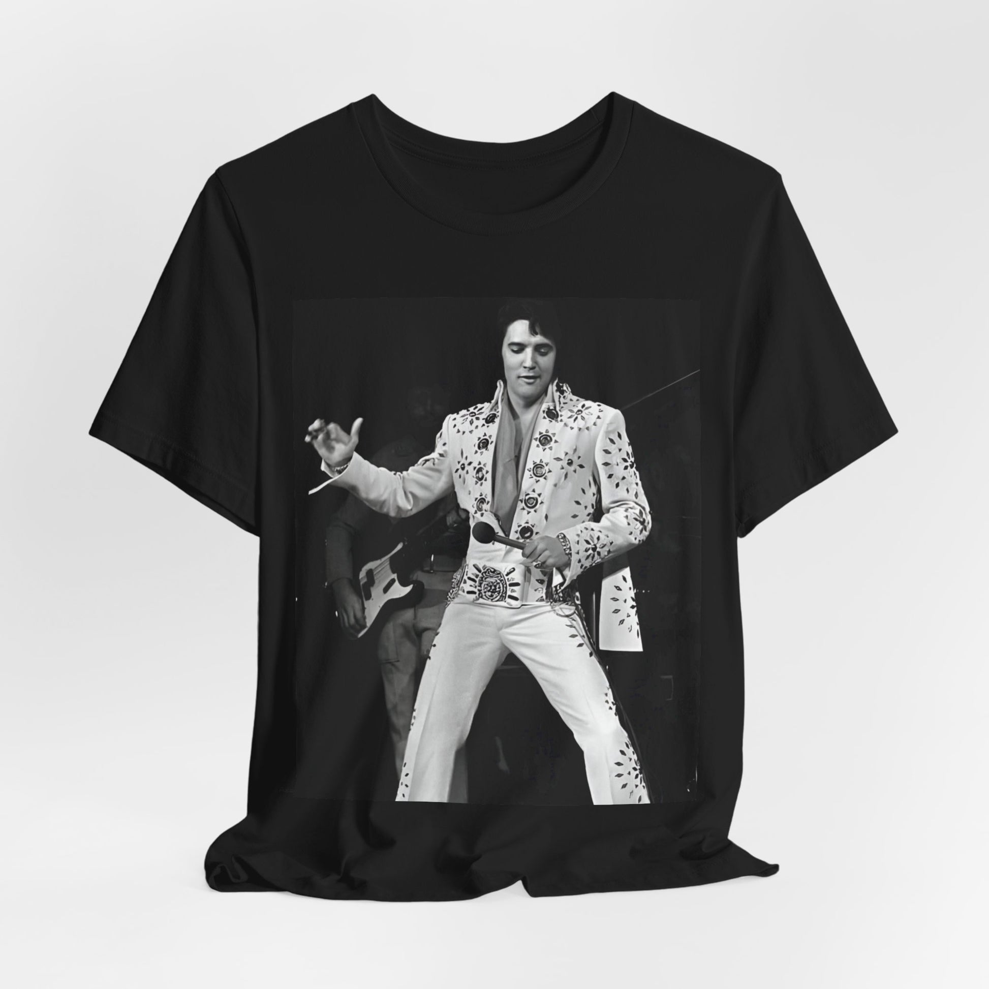 A black graphic t-shirt featuring a stylized graphic of Elvis Presley as The King of Rock 'n' Roll.