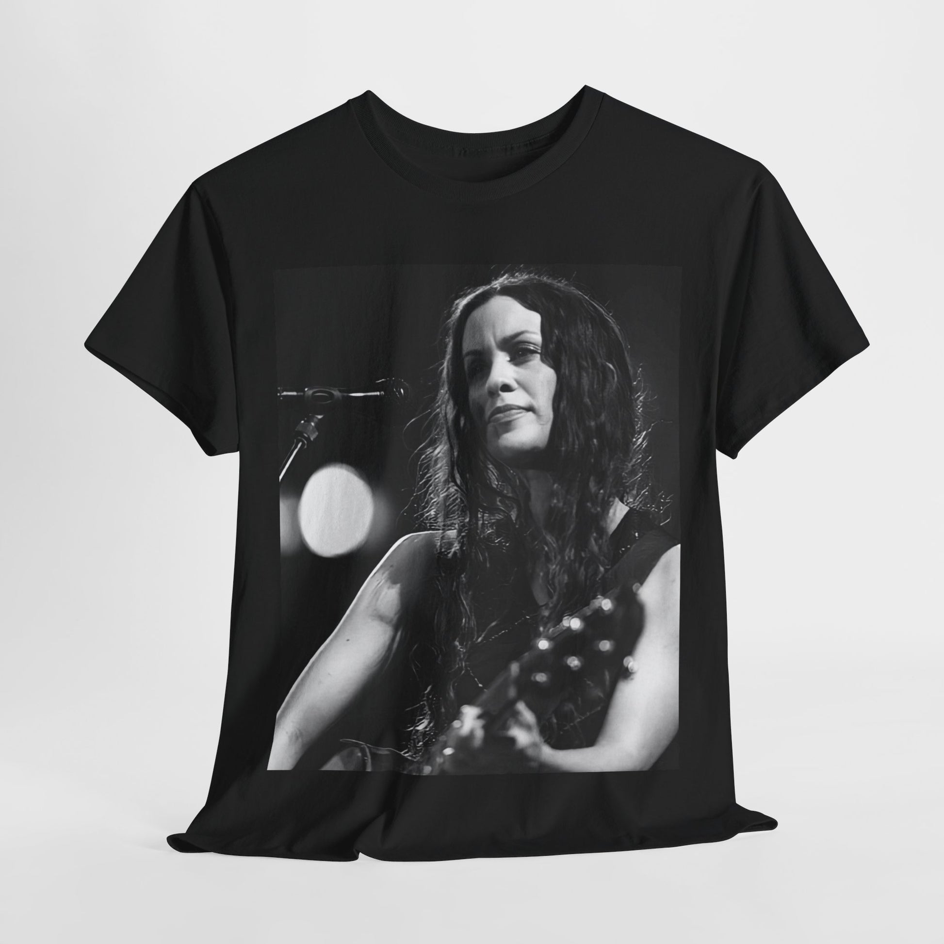 A black graphic t-shirt featuring a 90s-style graphic of Alanis Morissette playing a guitar, with a dynamic expression.