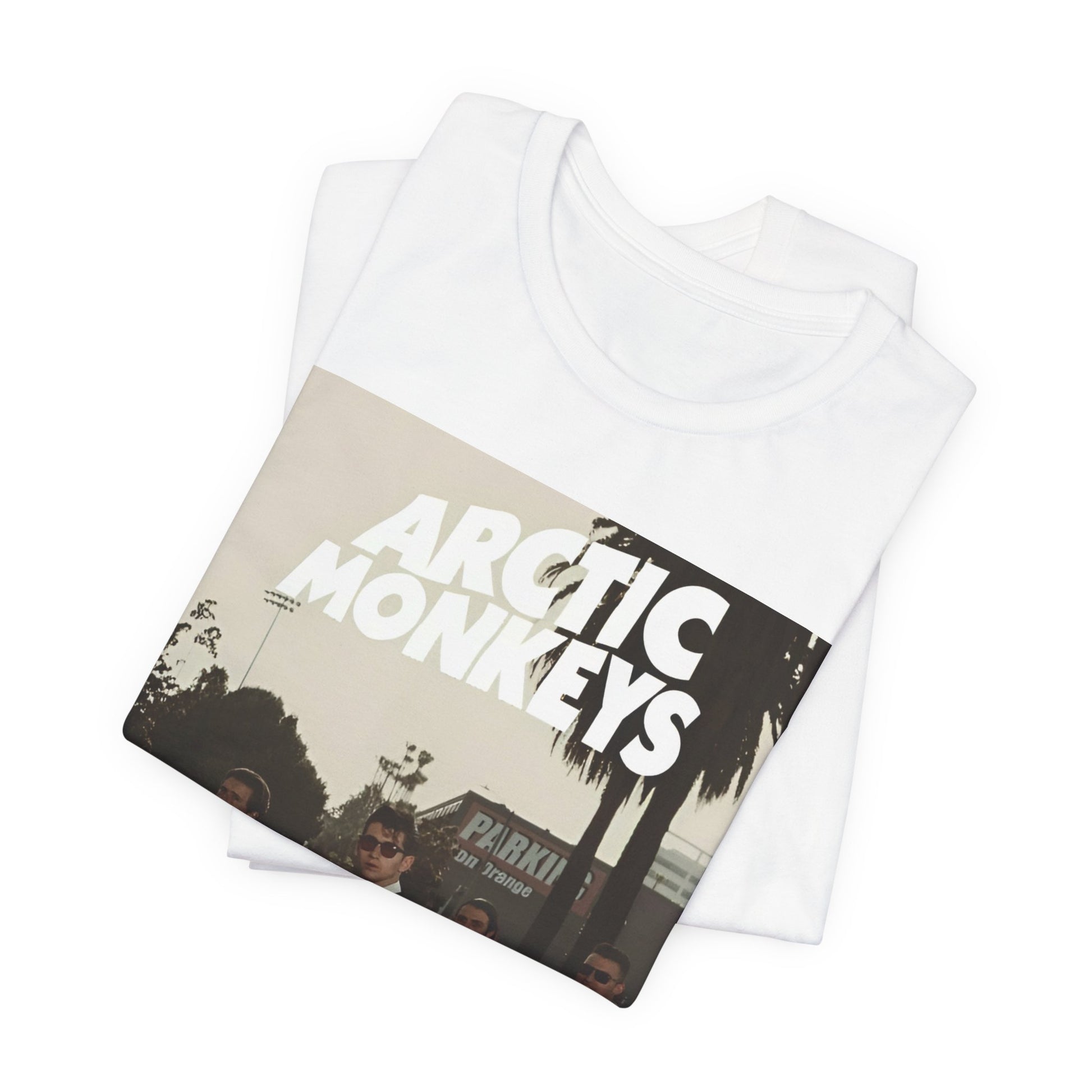 A black graphic t-shirt featuring Arctic Monkeys in a pose or setting similar to the iconic 'Abbey Road' album cover.