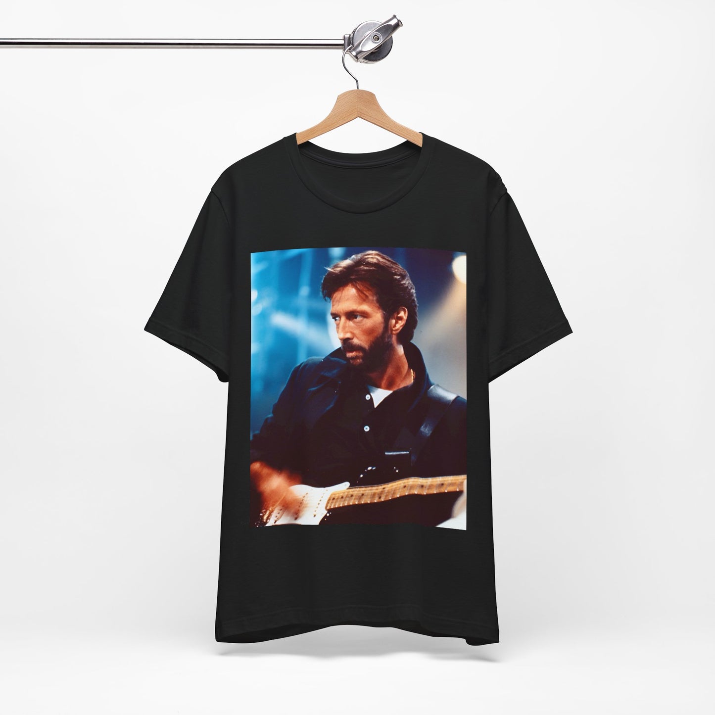 A black graphic t-shirt featuring a retro graphic or photo of Eric Clapton performing live on stage.